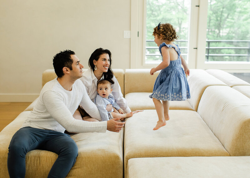 Relaxed candid lifestyle portrait of a laughing family in their home in NJ