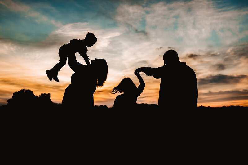 Bowling Green Kentucky family photographer. Silhouette of family of 4 at sunset.