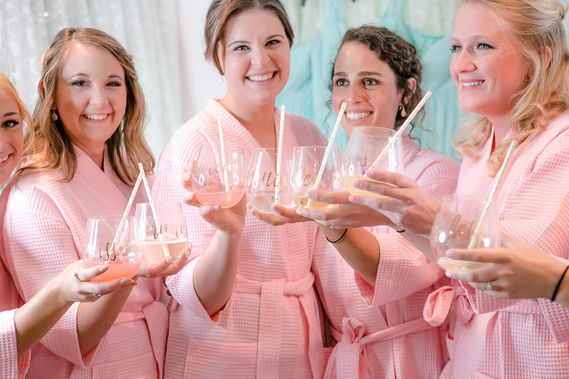 bridesmaids cheers with their cups