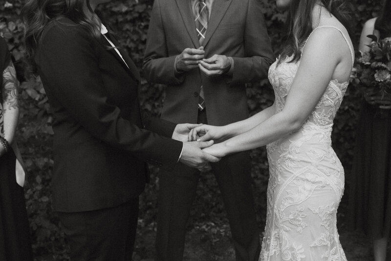 A close up of a couple holding hands during their wedding ceremony 