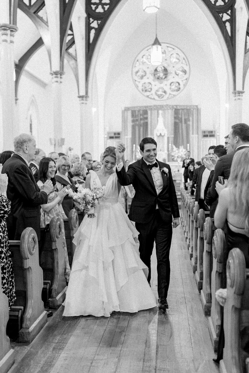 Black and white photo of bride and groom church ceremony exit.