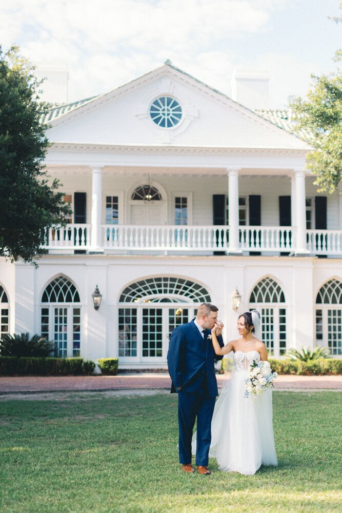 married couple walking in front of venue kissing
