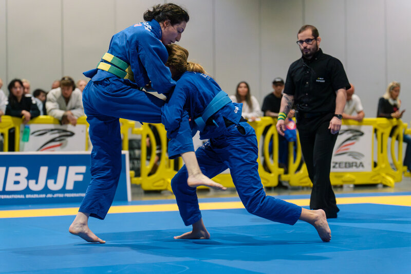 Two female blue belts grappling in the PNW at IBJJF