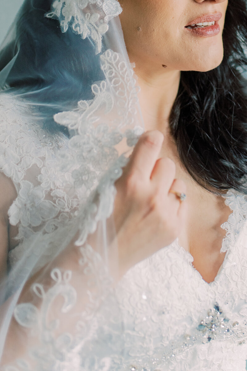Timeless bridal portrait in Burlington featuring a bride with bold curls and a lush bouquet