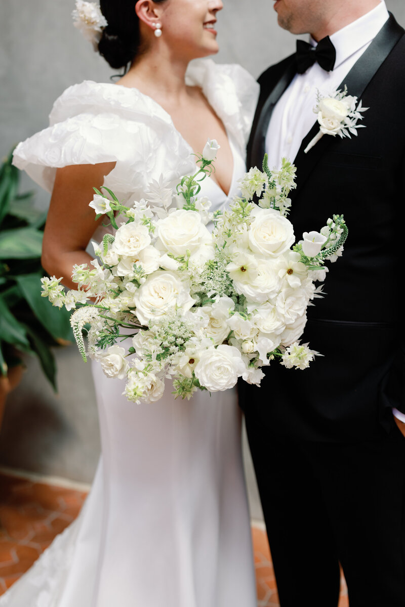Close-up of white floral bridal bouquet at Hotel Emma in San Antonio, Texas. A luxurious wedding venue with historic charm.