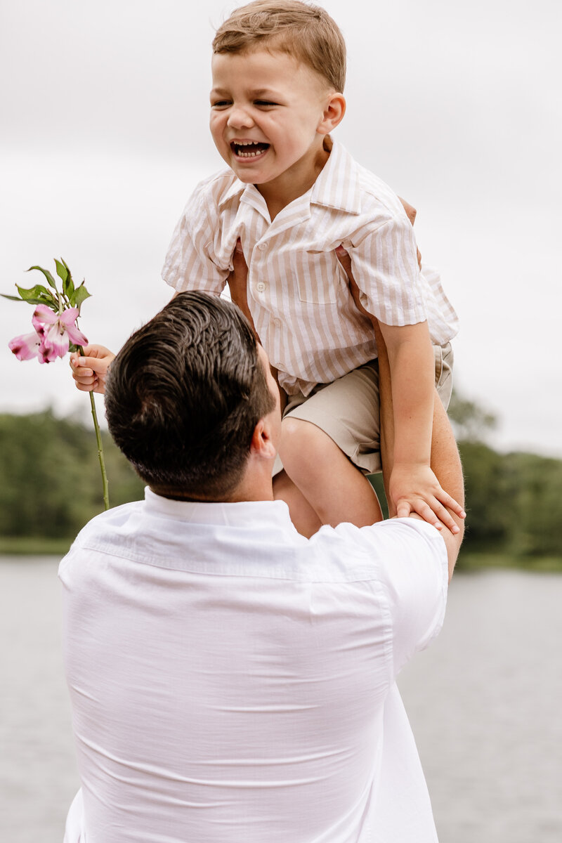 Candid Moment of Father Holding Son during a portrait session at a local lake 