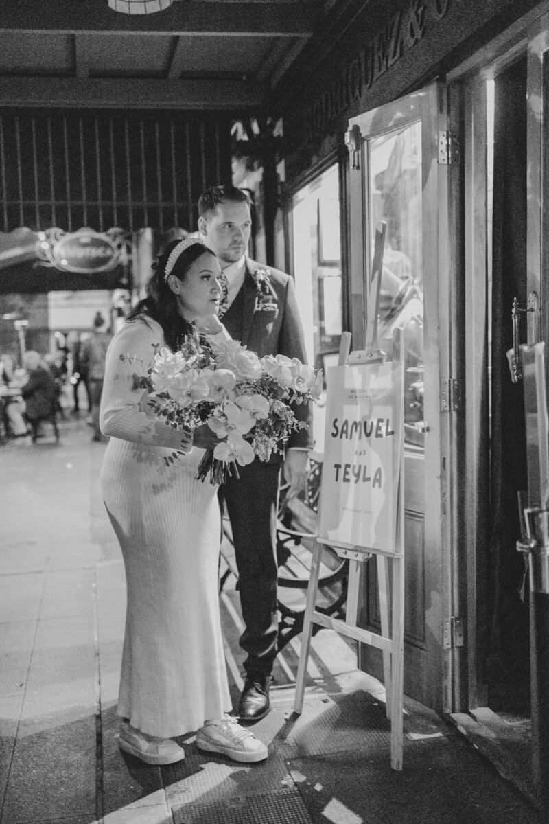 A wedding couple stands outside a wooloongabba reception in Brisbane ready to enter their wedding reception