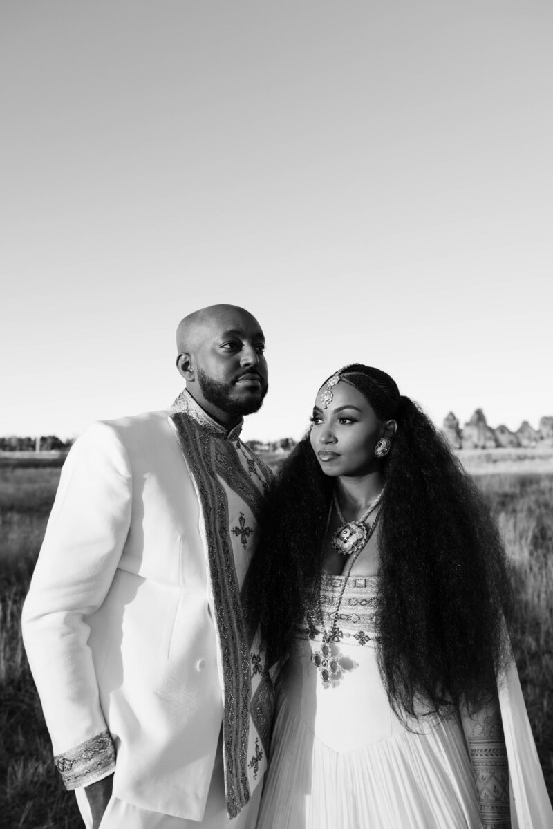 bride and groom holding hands for their luxury wedding portraits