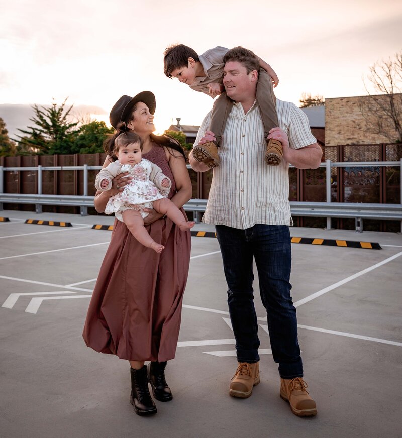 Family of four playing on a roof top carpark