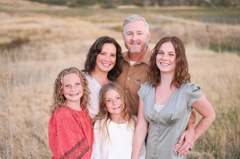family smiling during the golden hour light in Mapleton, Utah