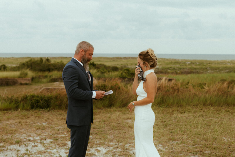 bride and groom reading vows