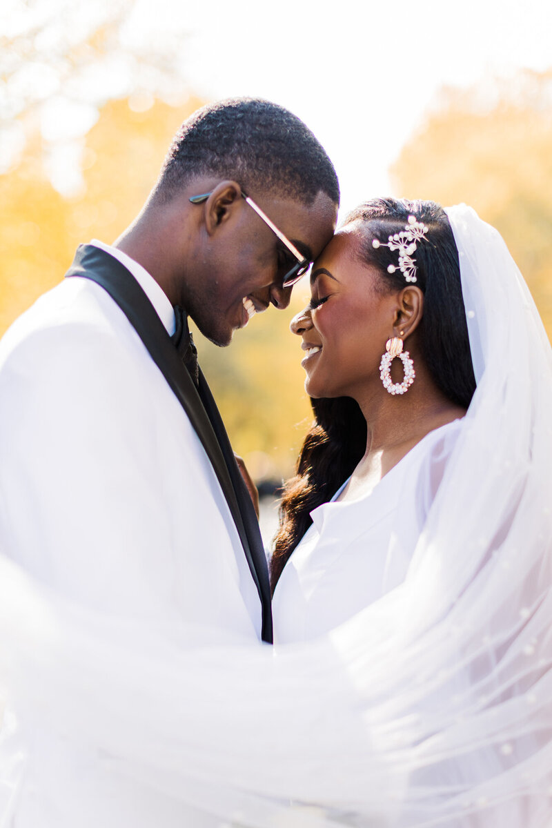 Bride and groom touch foreheads and smile in a close portrait at their intimate Hudson Valley wedding