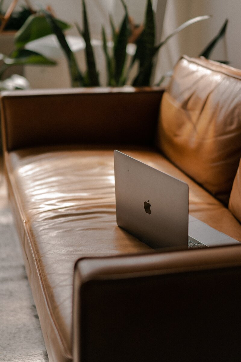 Macbook on a leather couch