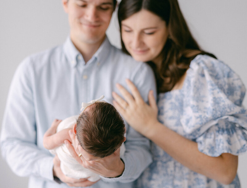 man and women smiling at newborn baby knoxville newborn photographer