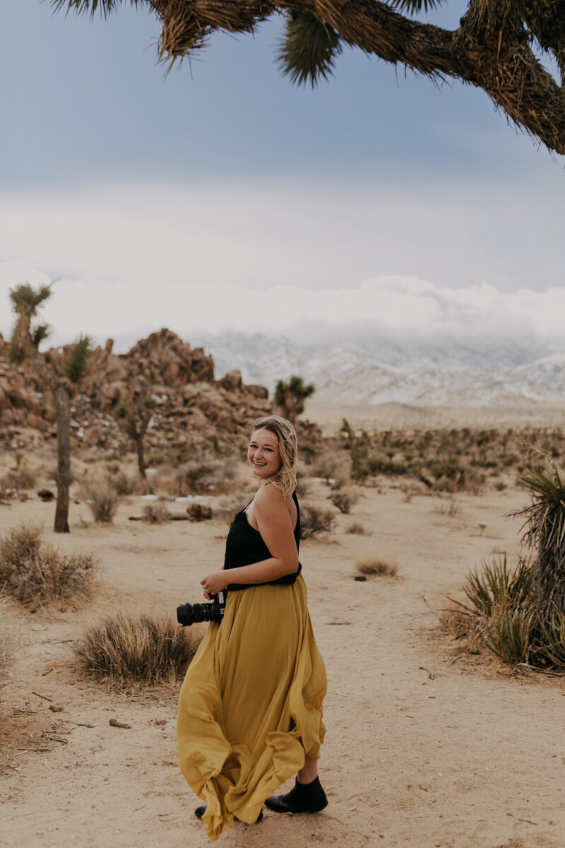 brianna kirk photography smiling looking back over her shoulder in joshua tree national park