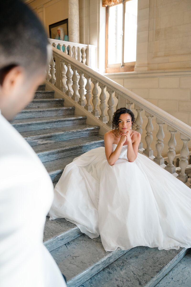 Newport Rhode Island Wedding Photographers | Rhode Island Caprio Captured Photography | Groom Sitting While Bride Leans On His Shoulder With Bright Pink And Orange Florals