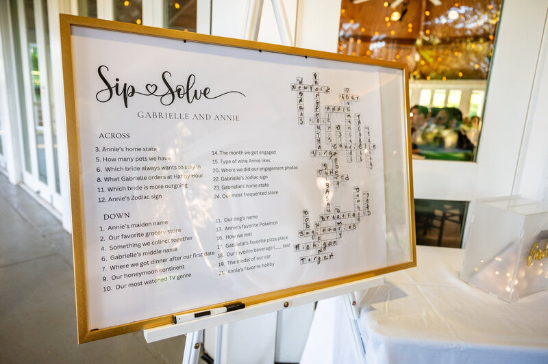 sip and solve wedding crossword dry erase puzzle on an easel with fun facts about lesbian couple gabrielle and annie