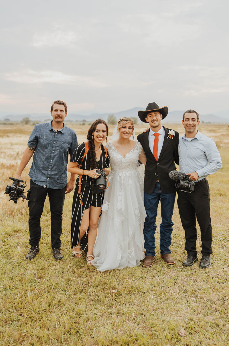 bride and groom with photographers