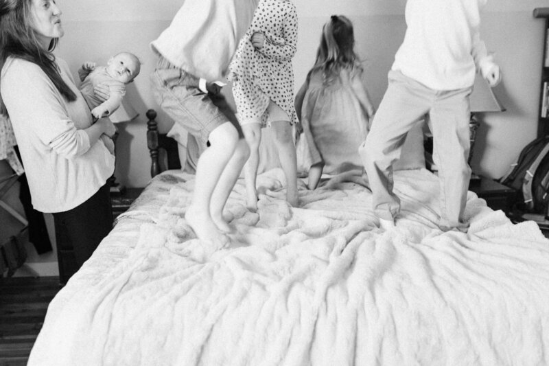 four siblings jump on the bed