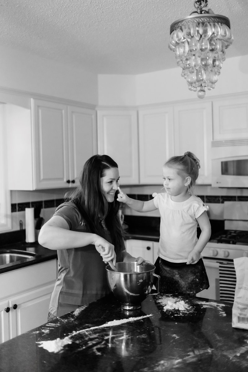 Mom and little girl baking cookies in the kitchen