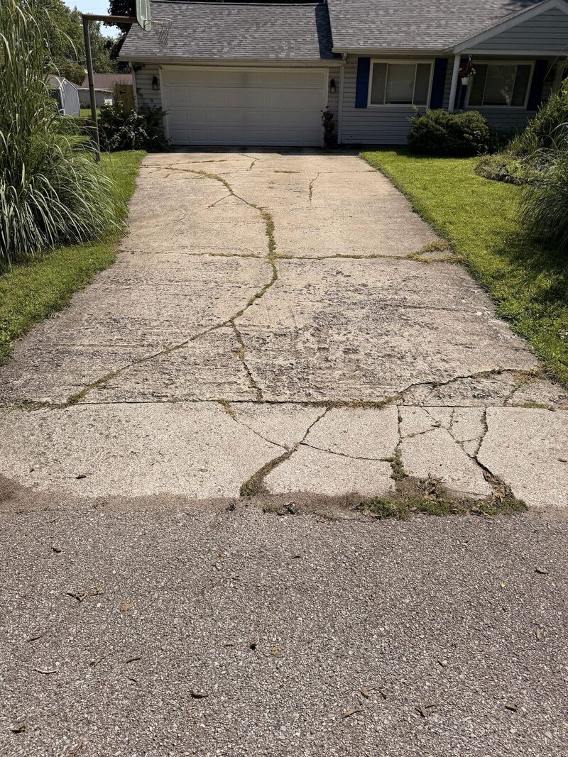 Before: badly cracked concrete driveway at a ranch home in Middlebury, IN
