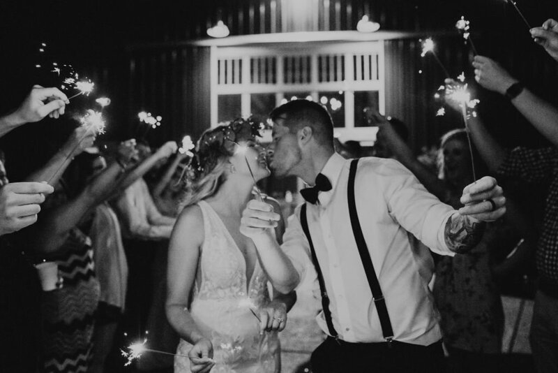 black and white photo of a sparkler wedding exit