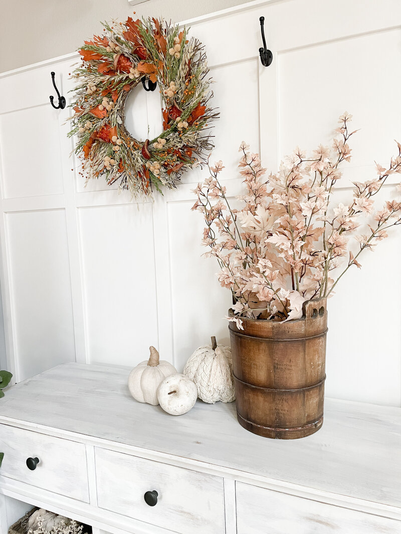 Fall faux foliage decor on entryway table 