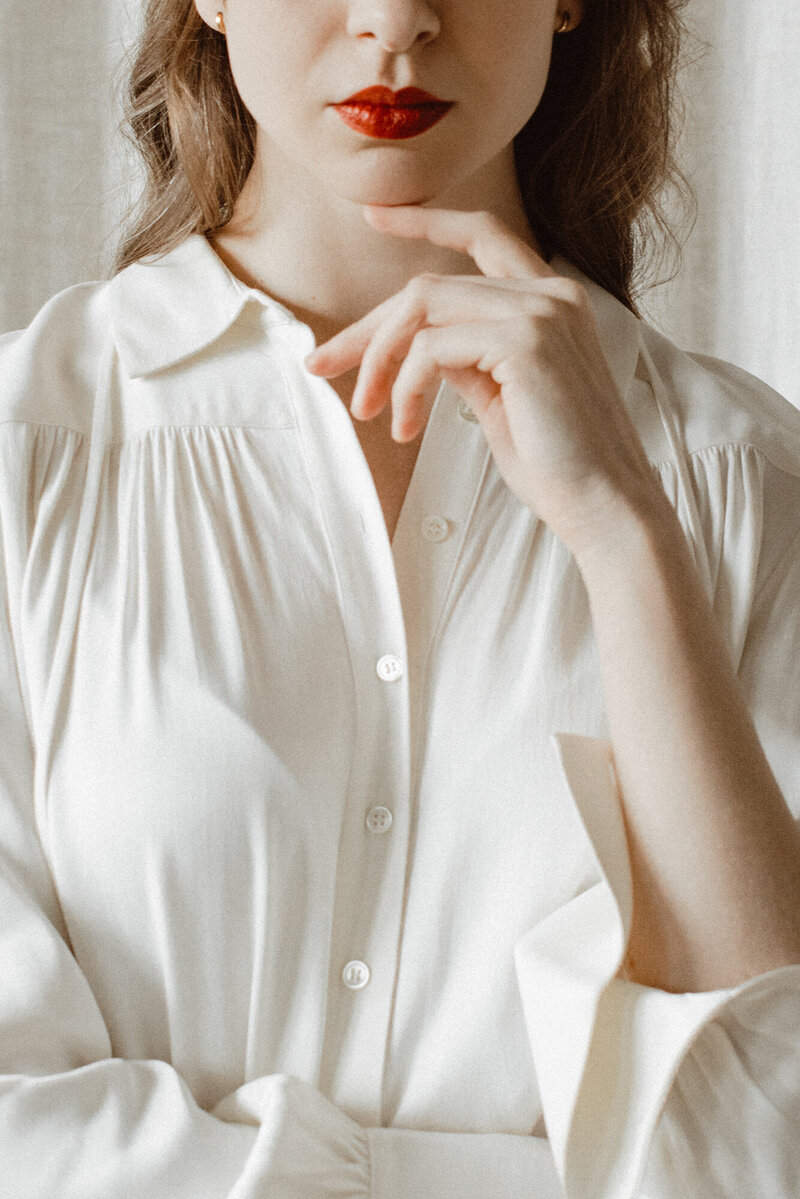 woman posing in a button up top