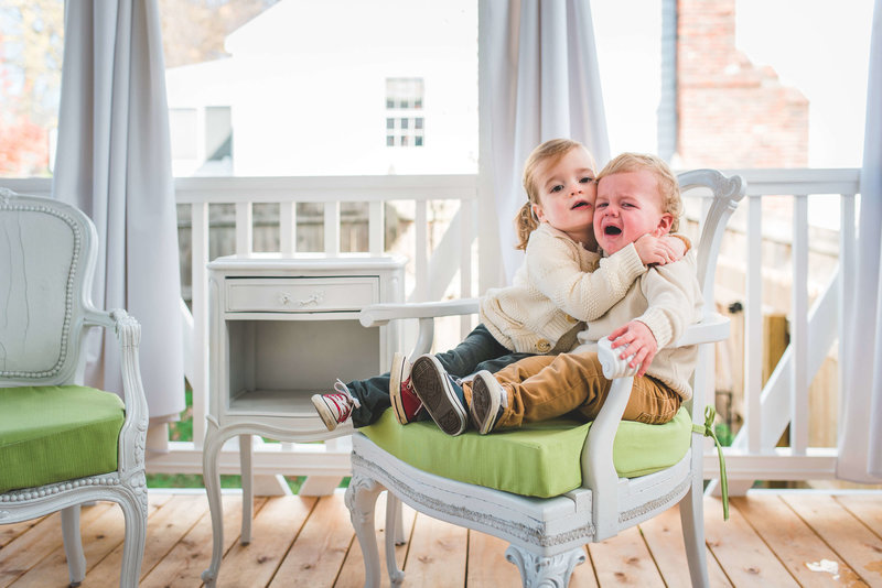 sibling toddlers in chair
