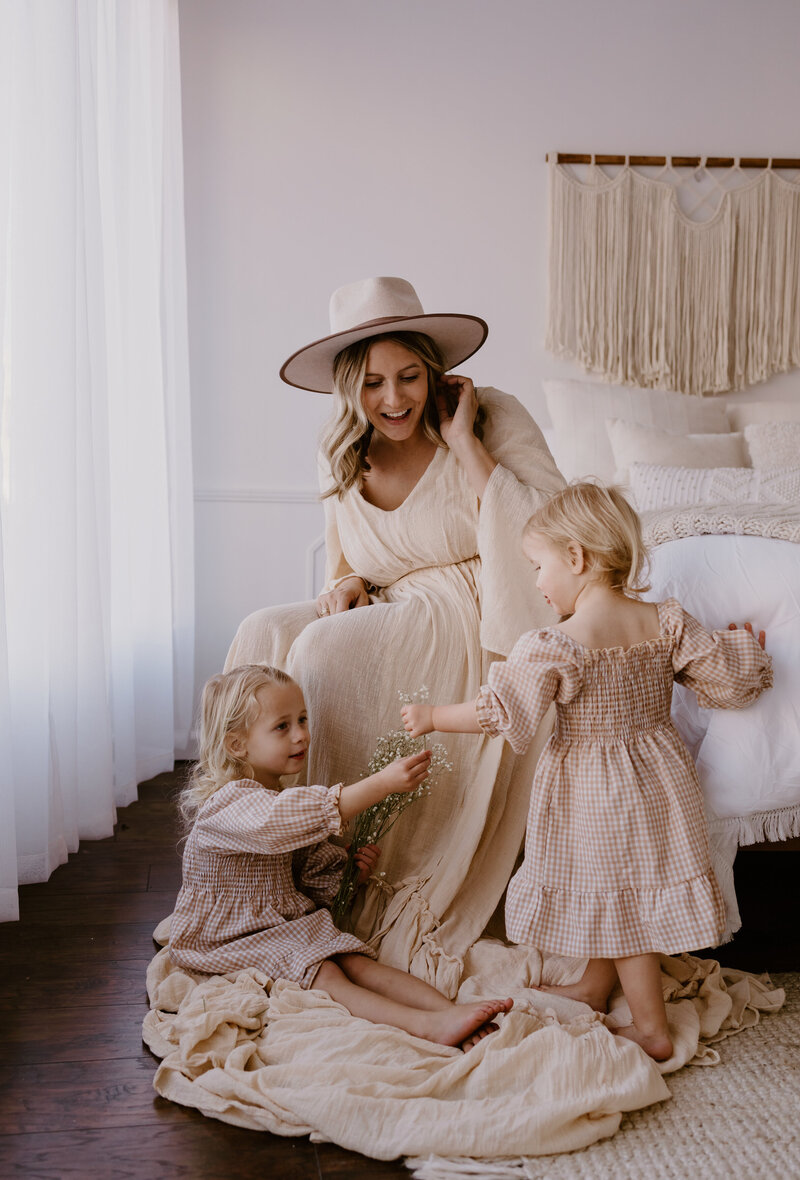 Mother and daughters in pretty dresses  admiring