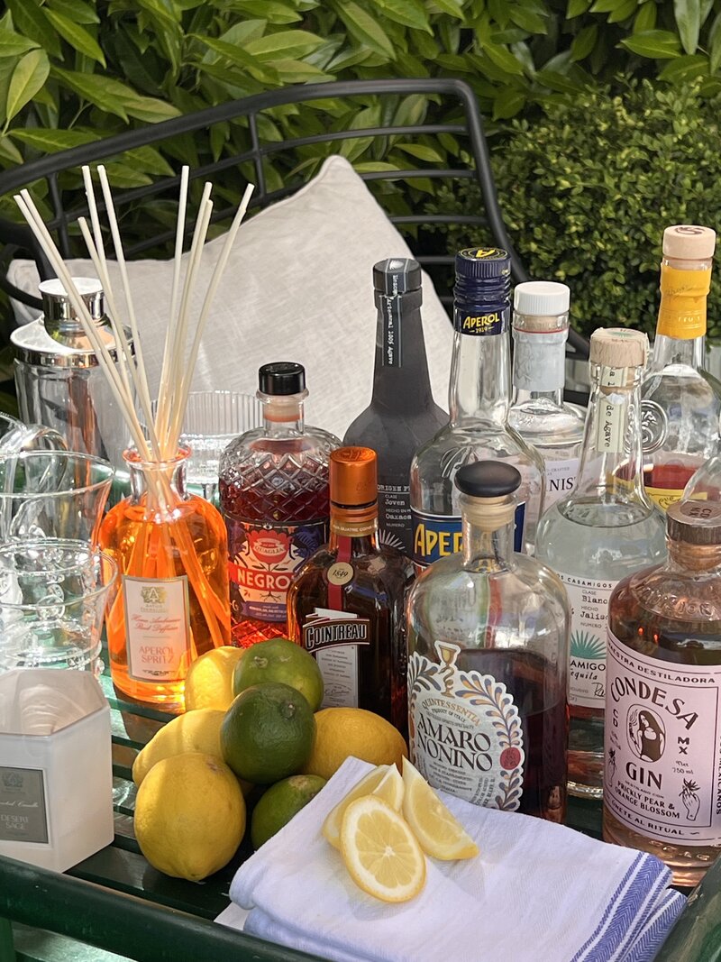 multiple spirits and citrus on an outdoor bar