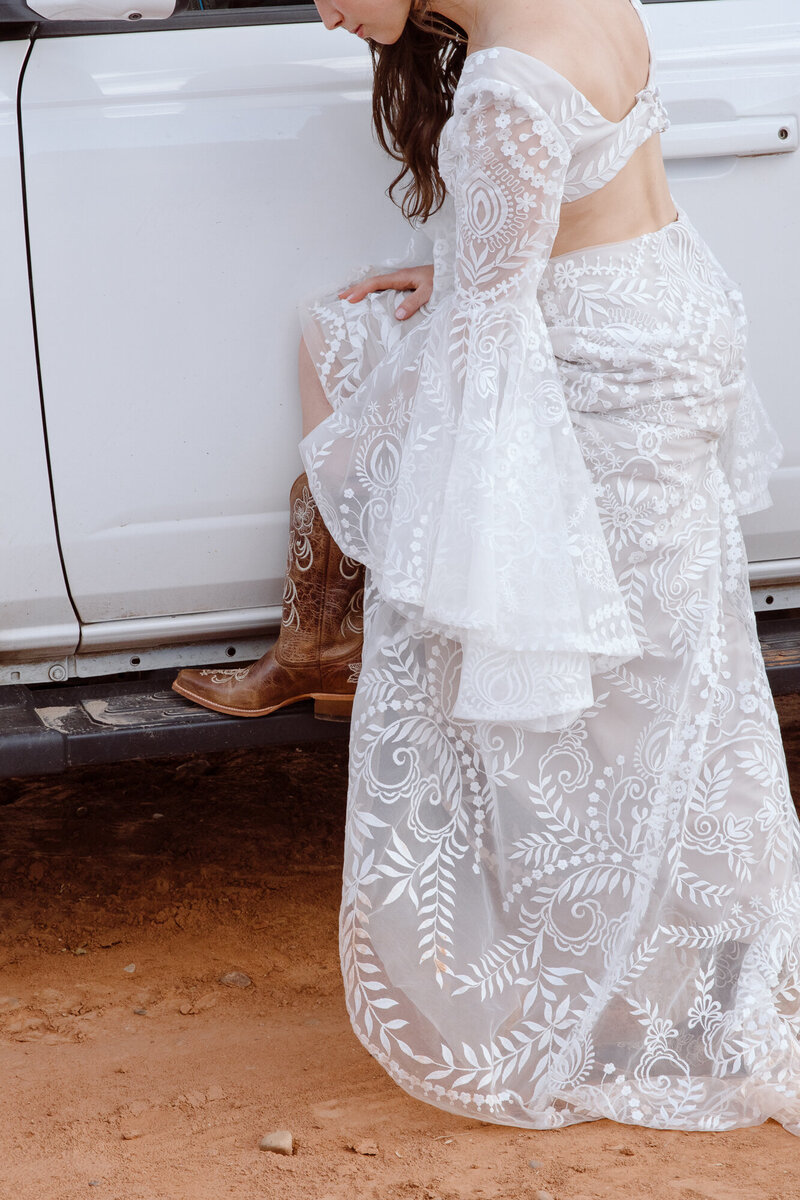 Adventure elopement with the bride getting ready by the bronco in Utah