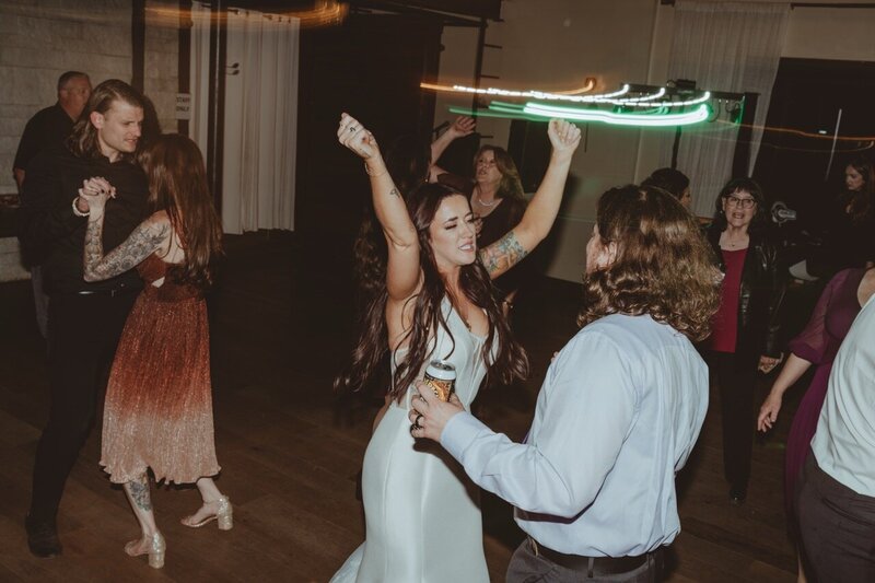 A man and woman dancing in a room full of people