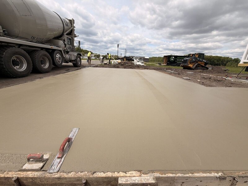 Mixer truck placing concrete for a large commercial slab in Elkhart, IN