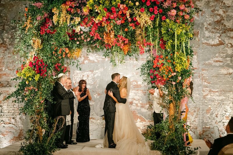 Black and white image of brittany and james kissing at their wedding ceremony