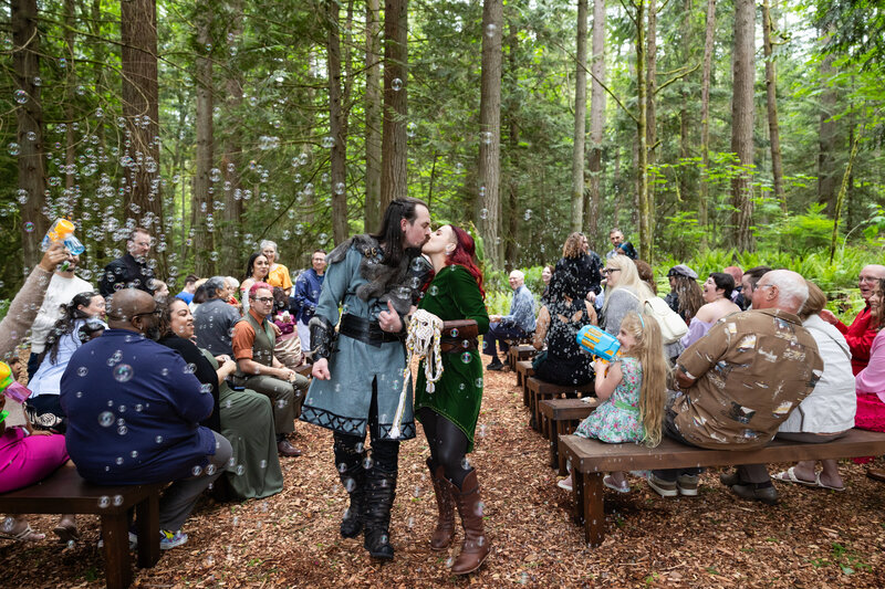 beautiful wedding set in the woods in seattle washington custom nordic grooms suit and green wedding dress