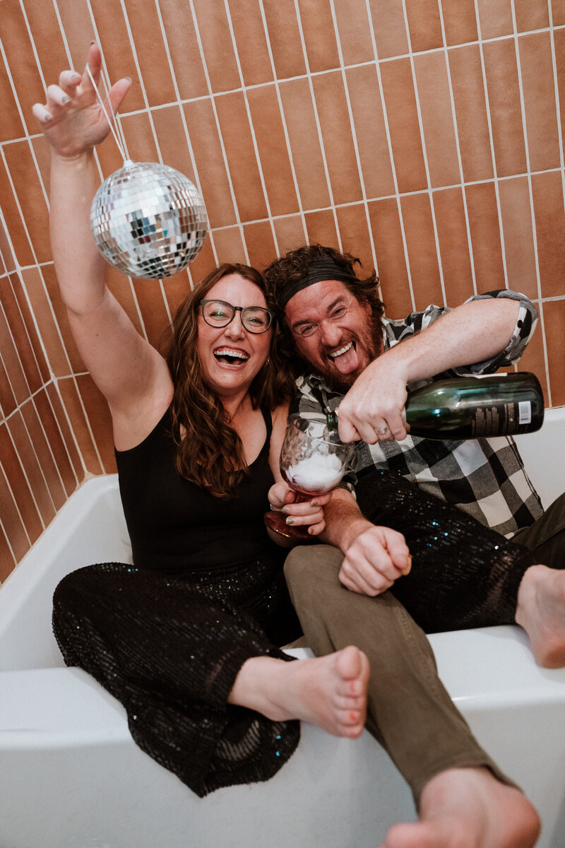 Couple partying in a bathtub with champagne and a disco ball in Breckenridge, Colorado.