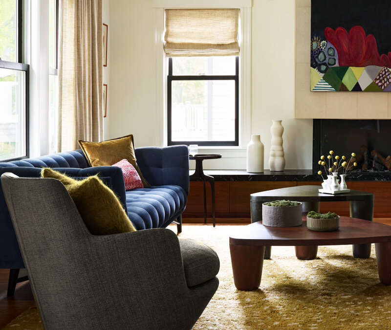 Historic home designer in Boston updates a Brookline home with modern furniture, blending original architecture with contemporary pieces.