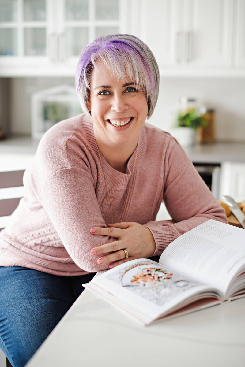 Heather Cook, the Social Stager, smiling at the camera in the kitchen.