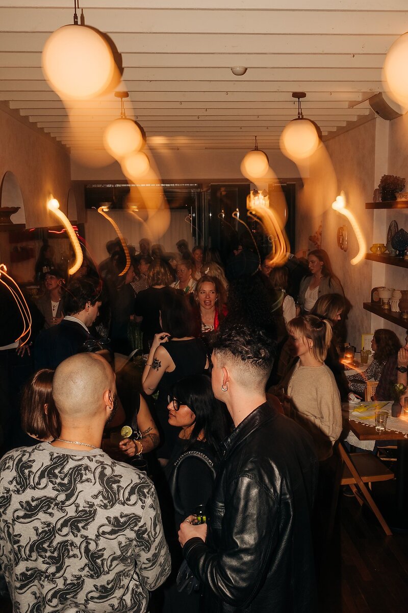 Friends toasting and celebrating during Dart Collective Chicago launch at Lou Lou by Lola Cafe