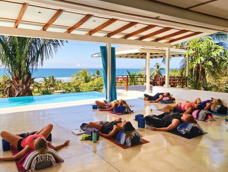 Restorative yoga session during yoga instructor training in Costa Rica's peaceful environment