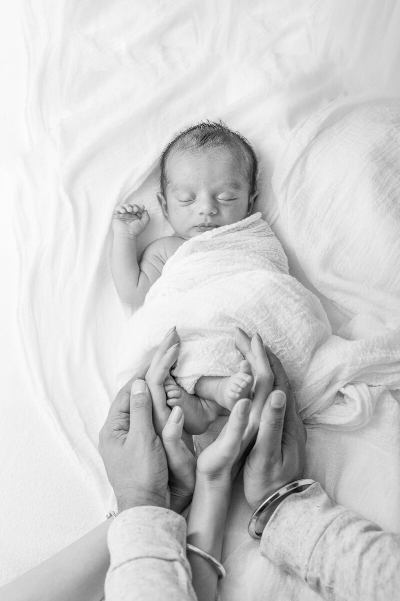 mother holding her baby and kissing him in the studio