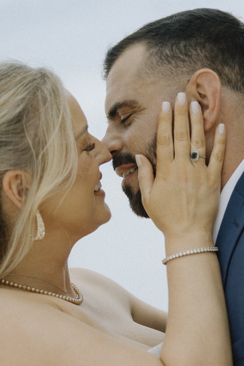 bride and groom lean in for a kiss