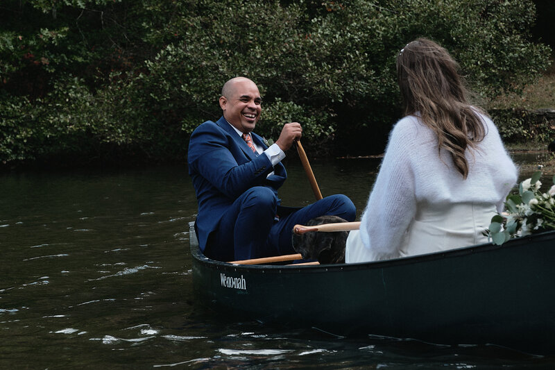 Eloping couple enjoys canoeing on their elopement day