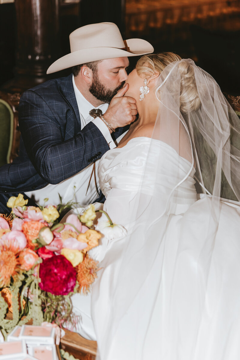Bride and Groom kissing with cathedral in background