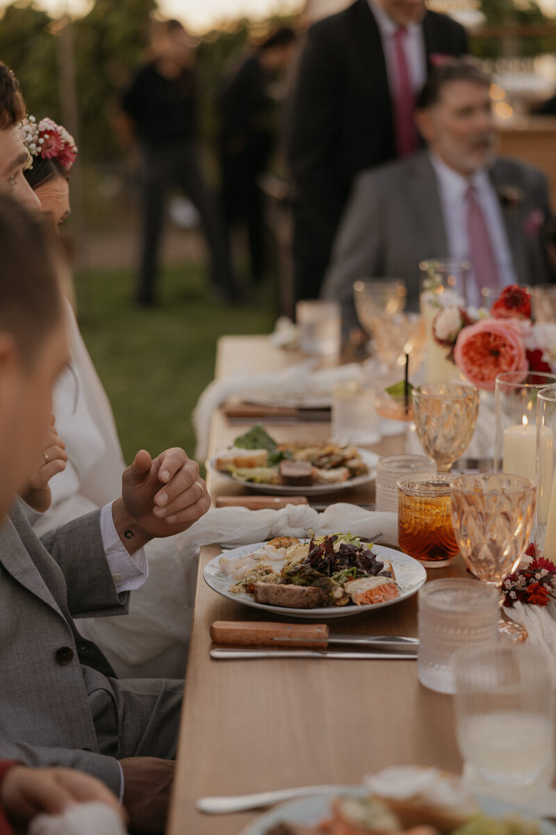 Outdoor wedding ceremony where the couple is sitting down for dinner in Washington