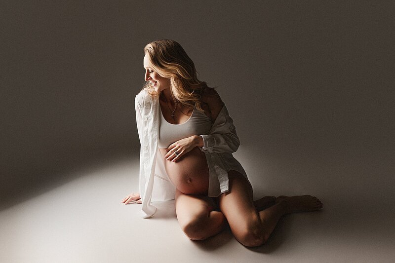 mom laughs during fun stress free maternity photoshoot in austin