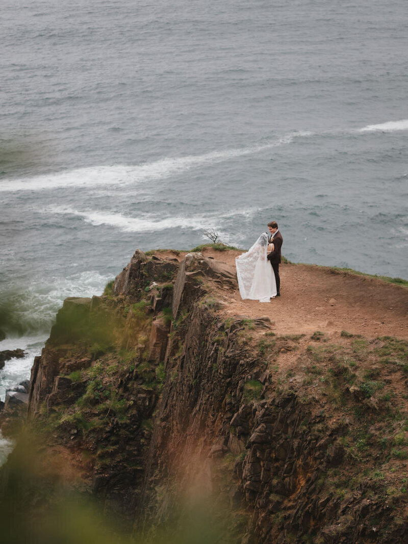couple standing on oregon coastline