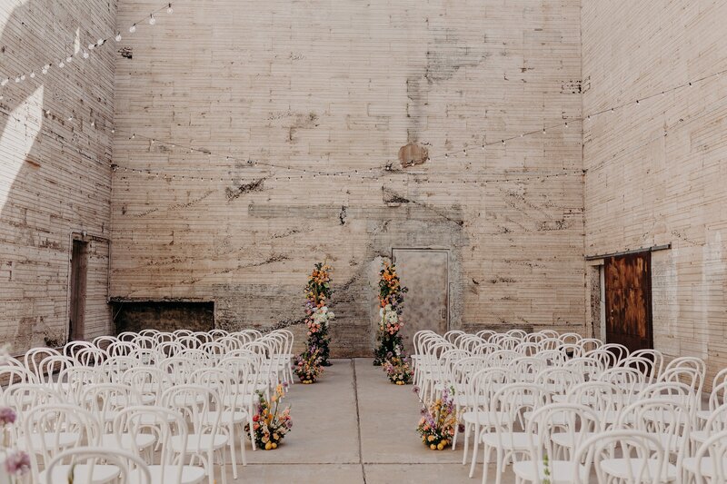 Wedding ceremony with florals setup in industrial space