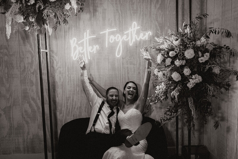 couple enjoying their photo booth and lounge on wedding day